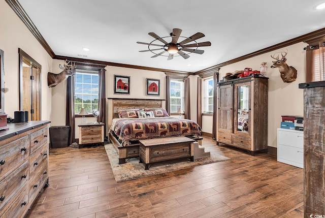 bedroom with ceiling fan, multiple windows, and crown molding