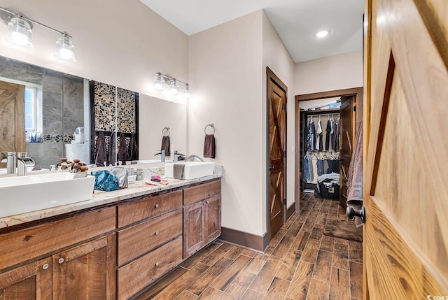 bathroom featuring walk in shower and vanity