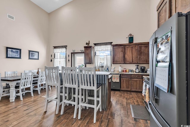 7299 Cartrette Rd, Aynor, SC 29511 - kitchen featuring freestanding refrigerator, a high ceiling, dishwasher, a center island, and light countertops