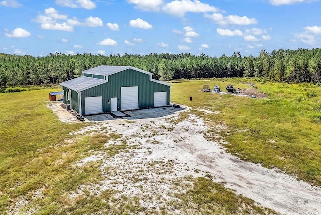 view of outdoor structure with a garage and a yard