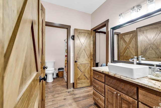 7299 Cartrette Rd, Aynor, SC 29511 - bathroom featuring vanity, toilet, and wood finished floors