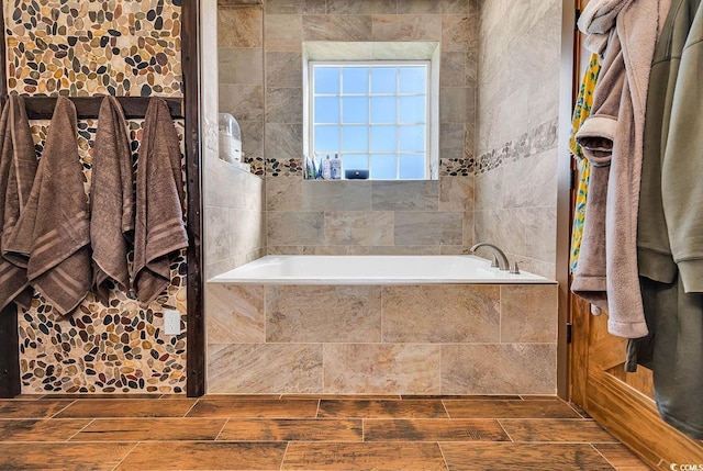 bathroom with tiled tub