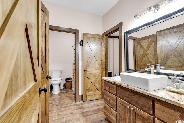 bathroom with toilet and vanity