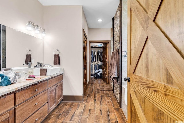 7299 Cartrette Rd, Aynor, SC 29511 - full bath featuring double vanity, wood finished floors, a walk in closet, and baseboards