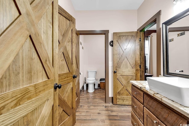 7299 Cartrette Rd, Aynor, SC 29511 - bathroom with vanity, wood finished floors, and toilet