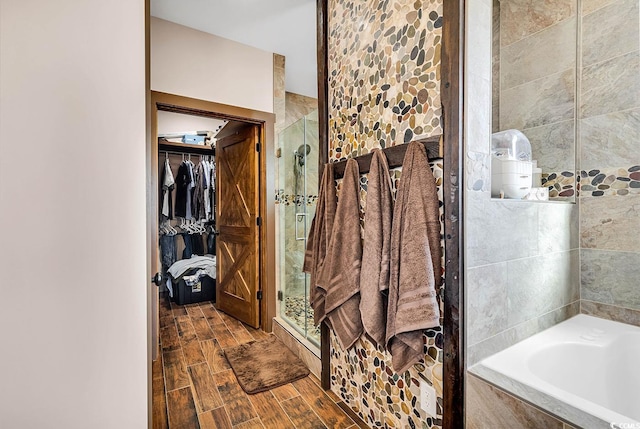 7299 Cartrette Rd, Aynor, SC 29511 - bathroom with a shower stall, a garden tub, a walk in closet, and wood finished floors