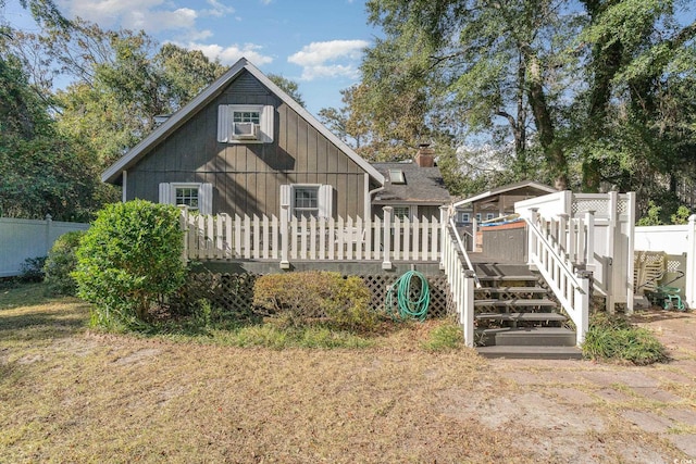 rear view of property featuring a deck