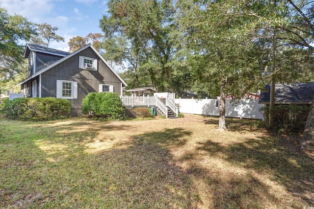 exterior space featuring a wall mounted AC and a yard