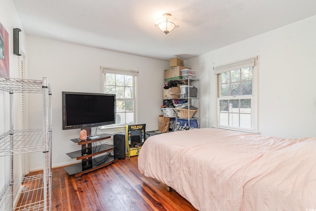 bedroom featuring hardwood / wood-style floors and a textured ceiling