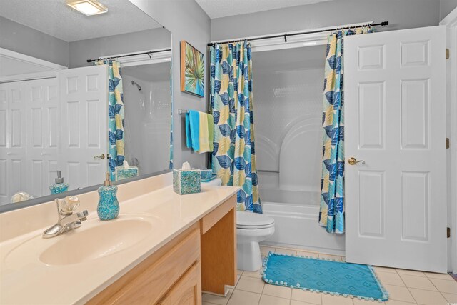 full bathroom with tile patterned floors, vanity, a textured ceiling, toilet, and shower / bathtub combination with curtain