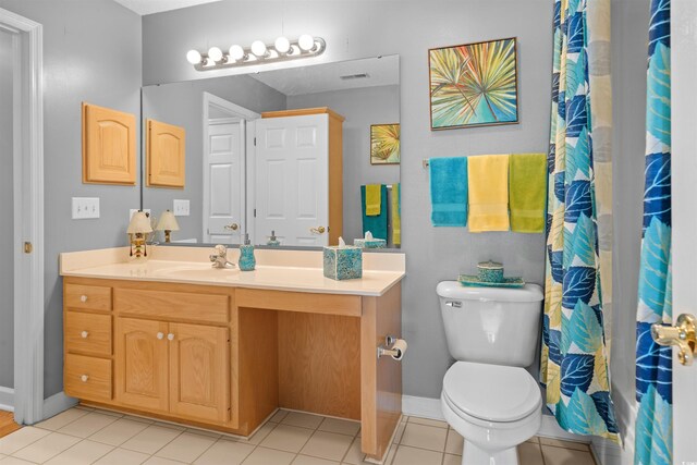 bathroom with tile patterned floors, vanity, and toilet