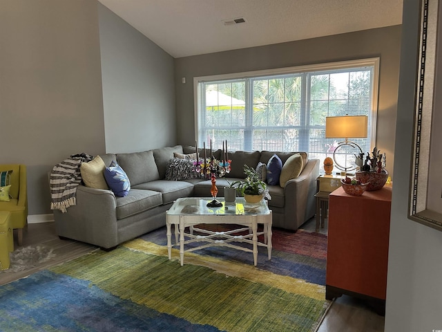 living area with plenty of natural light, wood finished floors, and visible vents