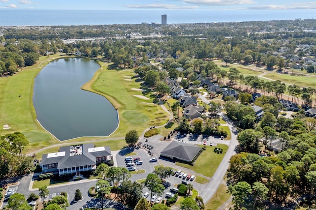 drone / aerial view with a water view and view of golf course