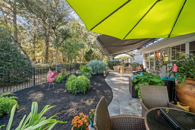 view of patio featuring fence and outdoor dining space