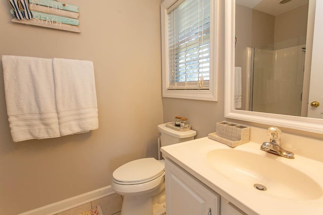 bathroom featuring toilet, vanity, tile patterned flooring, and a shower with shower door