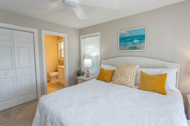 bedroom featuring connected bathroom, a closet, ceiling fan, and carpet floors