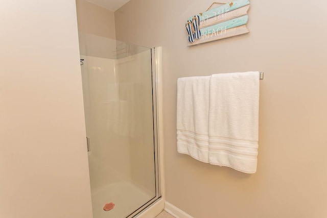 bathroom with a shower with door