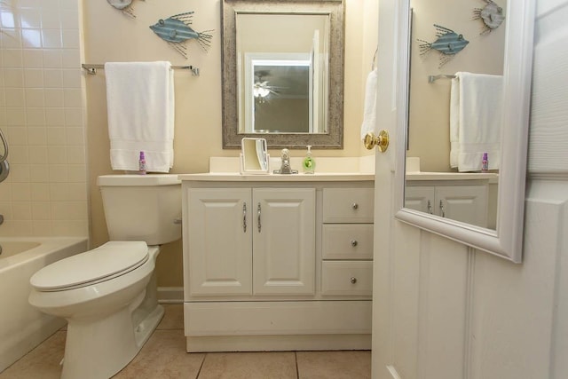 full bathroom featuring vanity, tile patterned flooring, toilet, and tiled shower / bath combo