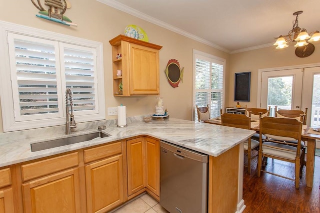 kitchen with sink, hanging light fixtures, crown molding, light wood-type flooring, and dishwasher