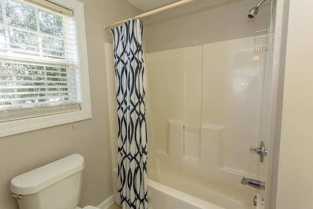 bathroom featuring shower / tub combo with curtain, toilet, and plenty of natural light