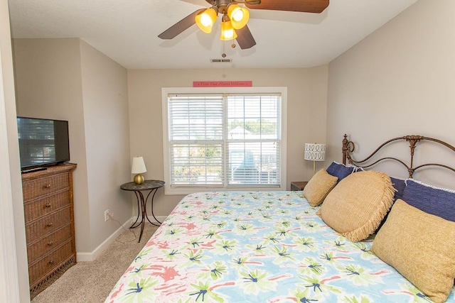 bedroom featuring light colored carpet and ceiling fan