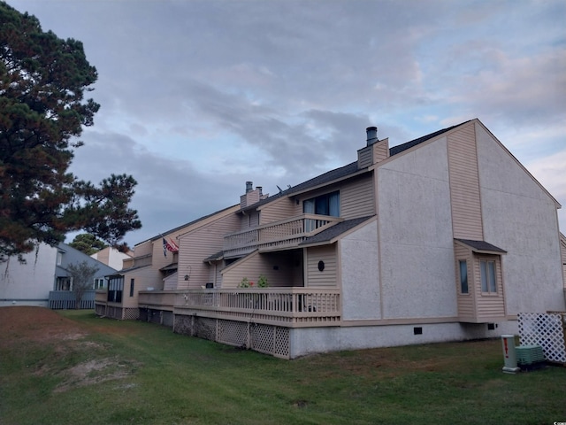 back of house with a lawn and cooling unit