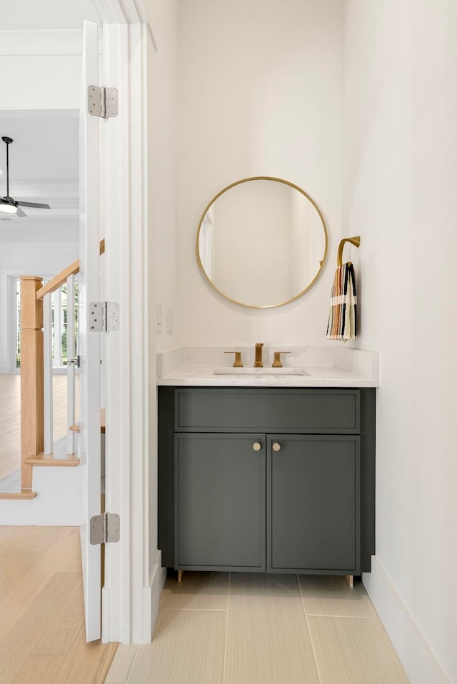 bathroom featuring hardwood / wood-style floors, ceiling fan, and vanity