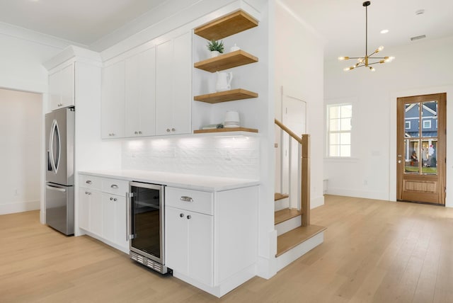 2313 Summersweet Ln, Myrtle Beach, SC 29579 - kitchen with beverage cooler, stainless steel fridge, open shelves, light wood-style flooring, and light countertops