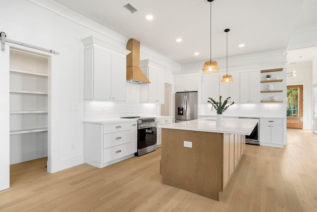 kitchen with stainless steel dishwasher, sink, a kitchen island with sink, and light wood-type flooring