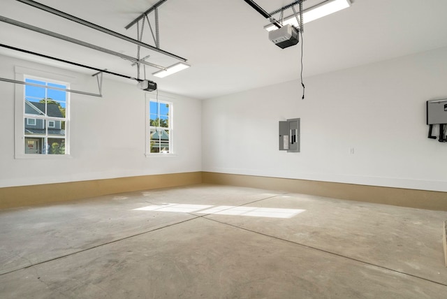 garage with electric panel and a garage door opener