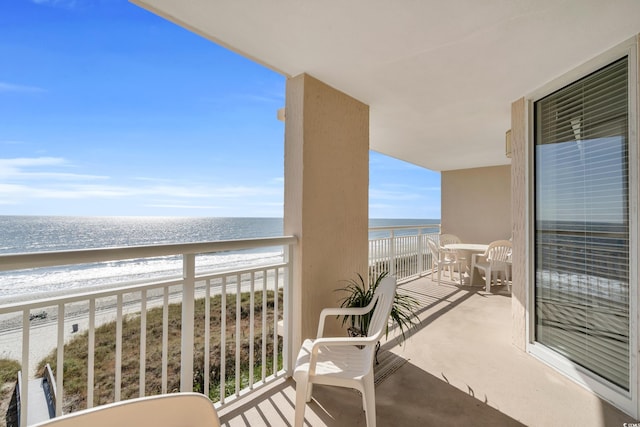 balcony with a view of the beach and a water view