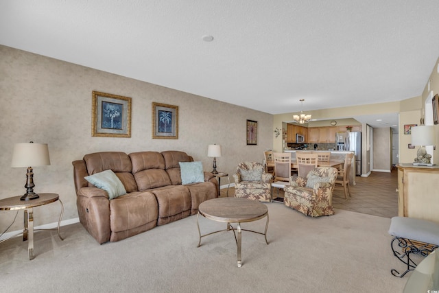 carpeted living room featuring a textured ceiling and a notable chandelier