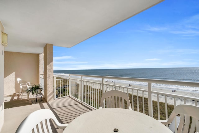 balcony featuring a water view and a view of the beach