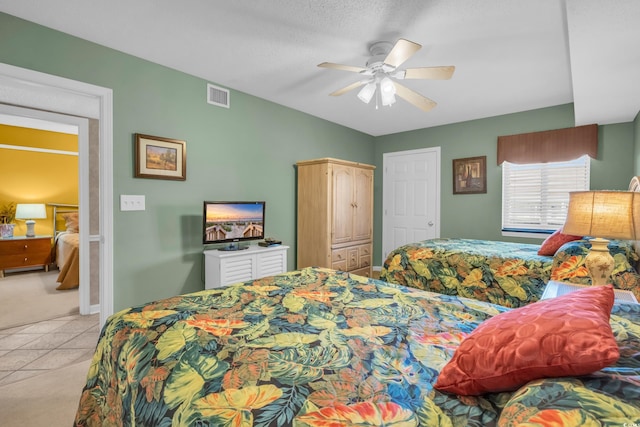 tiled bedroom with ceiling fan