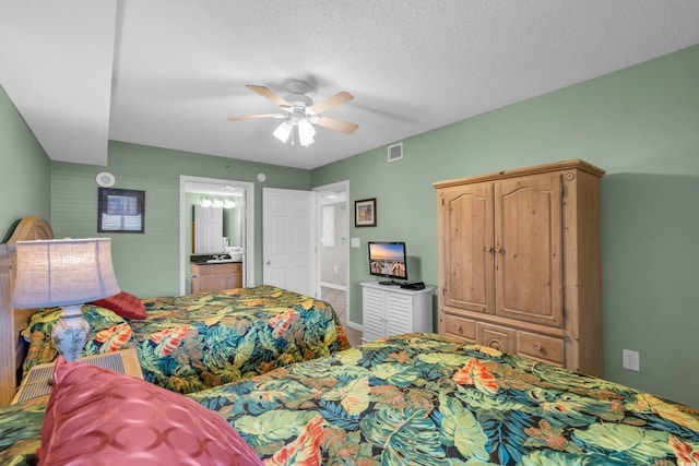 bedroom with ensuite bathroom, a textured ceiling, and ceiling fan