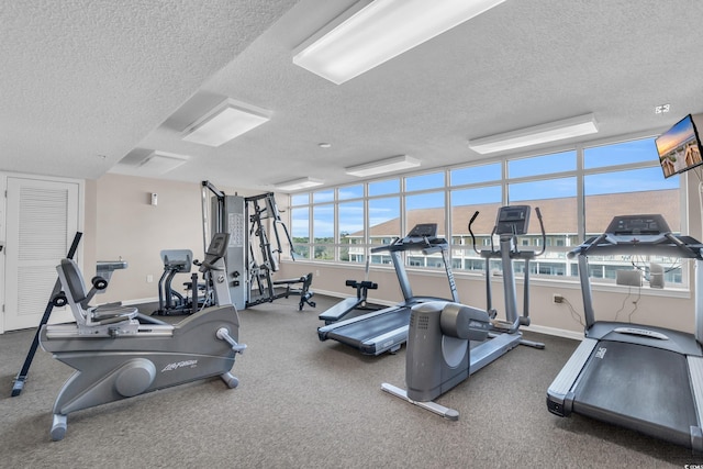 exercise room featuring a textured ceiling