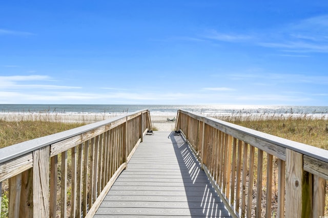 view of home's community featuring a beach view and a water view