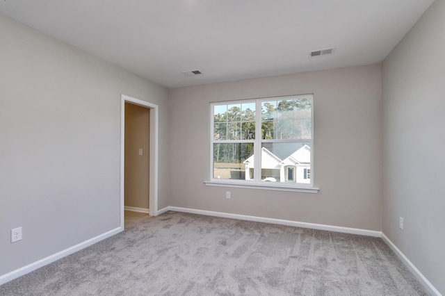 empty room featuring light colored carpet