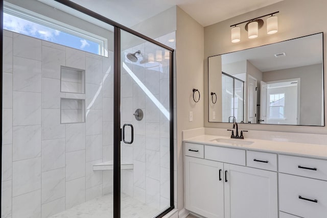 bathroom featuring vanity and an enclosed shower