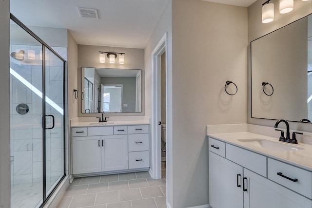 bathroom featuring toilet, vanity, tile patterned floors, and a shower with door