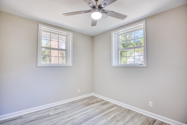 615 1st Ave N, Surfside Beach, SC 29575 - spare room featuring light wood-style flooring, plenty of natural light, baseboards, and ceiling fan