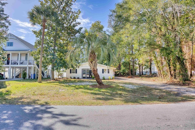 615 1st Ave N, Surfside Beach, SC 29575 - view of front of property featuring stairway, a front yard, and covered porch