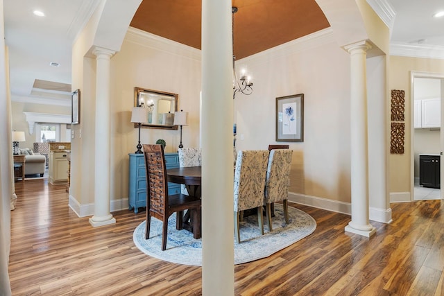 dining area featuring ornamental molding and light hardwood / wood-style flooring