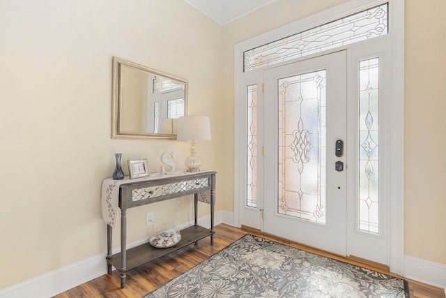 foyer entrance with crown molding, hardwood / wood-style flooring, and plenty of natural light