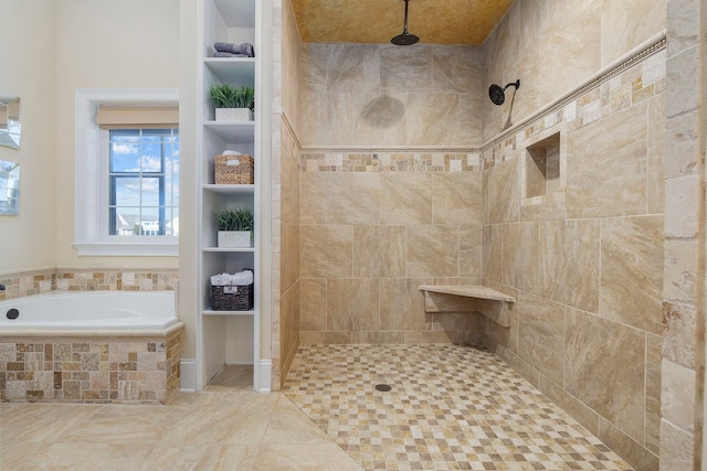 bathroom featuring tile patterned floors and separate shower and tub