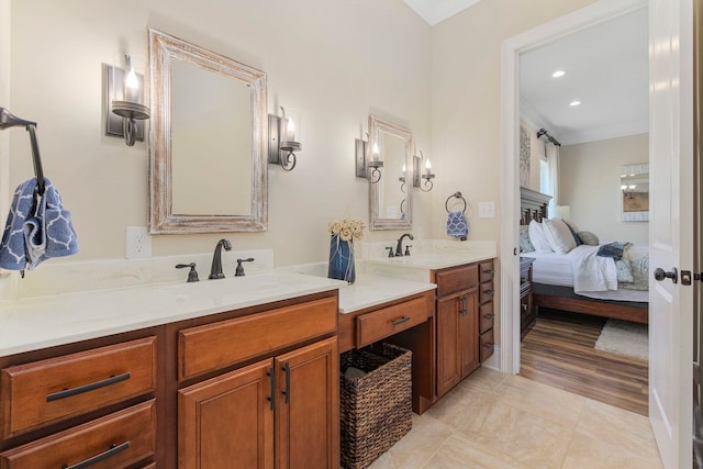 bathroom with vanity, crown molding, and hardwood / wood-style flooring