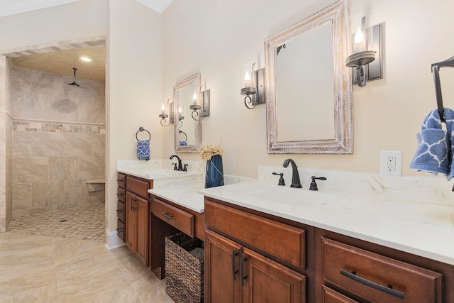 bathroom with vanity, tiled shower, and tile patterned floors