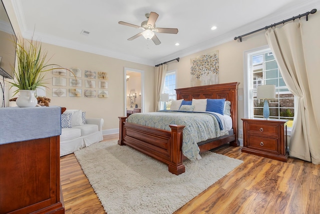 bedroom featuring connected bathroom, ceiling fan, ornamental molding, and hardwood / wood-style floors