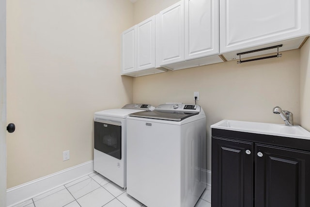 laundry area featuring cabinets, sink, separate washer and dryer, and light tile patterned floors