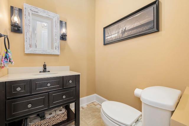 bathroom featuring vanity, toilet, and tile patterned flooring